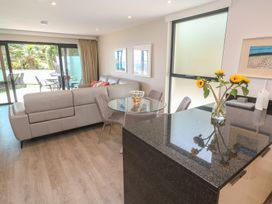A living room with a sofa and dining table at Peninsula Apartment 2 in St Ives
