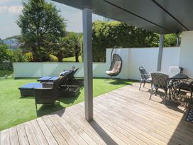An outdoor area with seating and loungers at Peninsula Apartment 2 St Ives