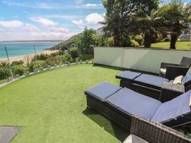 A garden with seating and ocean view at Peninsula Apartment 2 in St Ives