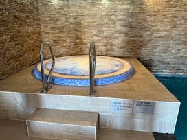 A jacuzzi with steps in a room at Peninsula Apartment 2 St Ives