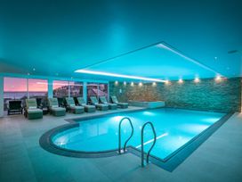 A swimming pool with lounge chairs at Peninsula Apartment 2 in St Ives