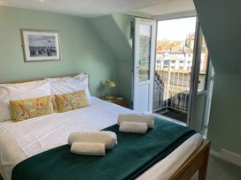 A bedroom with a bed and balcony at Monarch Brewers Quay Harbour