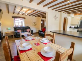 A dining area with table and chairs at Bwthyn Y Wennol Dolwen near Abergele