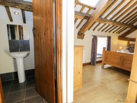 A bedroom with a bed and a sink visible at Bwthyn Y Wennol Dolwen near Abergele
