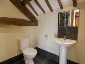 A bathroom with a toilet and sink at Bwthyn Y Wennol in Dolwen near Abergele