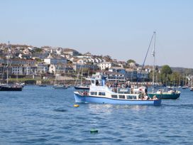 A boat on the river with buildings in the background at Dragonflies & Seahorses in Falmouth
