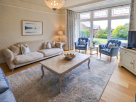 A living room with a sofa and two armchairs at Fern Bank in Penrith