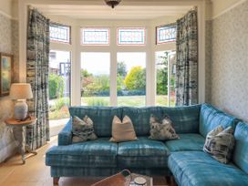 A living room with a sofa and lamp at Fern Bank in Penrith