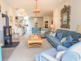 A living room with a sofa, coffee table, and fireplace at Fern Bank in Penrith
