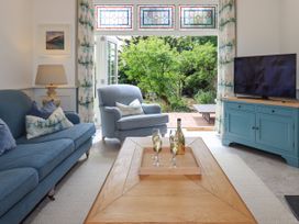 A living room with a sofa, chair, and television at Fern Bank in Penrith