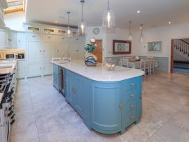 A kitchen with an island and dining area at Fern Bank in Penrith