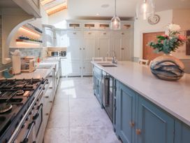 A kitchen with cabinets, appliances, and a kitchen island at Fern Bank in Penrith