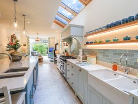 A kitchen with a sink, stove, and kitchen island at Fern Bank in Penrith