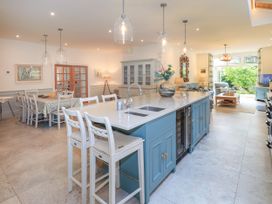 A kitchen with an island and dining area at Fern Bank in Penrith