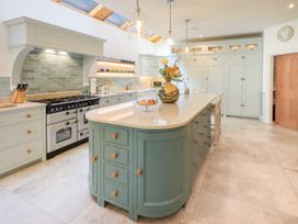A kitchen with an island and stove at Fern Bank in Penrith