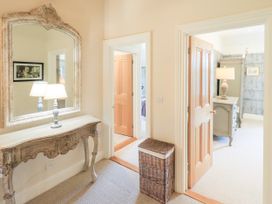 A hallway with a console table and mirror at Fern Bank in Penrith