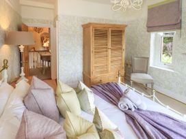 A bedroom with a bed and wardrobe at Fern Bank in Penrith