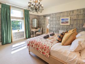 A bedroom with a bed and mirror at Fern Bank in Penrith