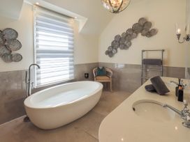 A bathroom with a bathtub and sink at Fern Bank in Penrith