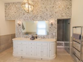 A bathroom with a vanity and mirror at Fern Bank in Penrith