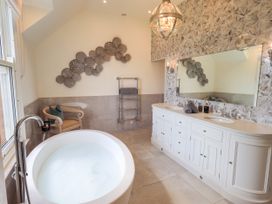 A bathroom with a bathtub and vanity at Fern Bank in Penrith