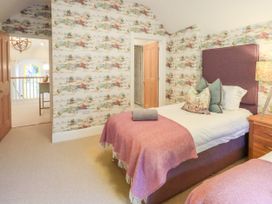 A bedroom with beds and a table at Fern Bank in Penrith