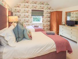A bedroom with two beds and a dresser at Fern Bank in Penrith