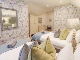A bedroom with two beds and a dresser at Fern Bank in Penrith