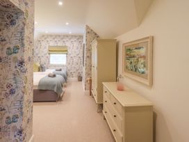 A bedroom with two beds and a dresser at Fern Bank in Penrith