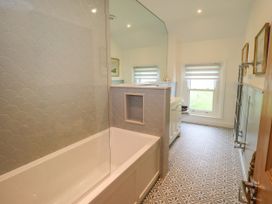 A bathroom with a bathtub and sink at Fern Bank in Penrith
