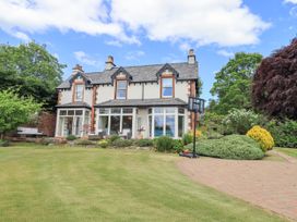 A house with a lawn and garden at Fern Bank in Penrith