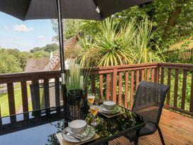 An outdoor dining area with a table and chairs at Lavender Lodge in St. Ann's Chapel, Cornwall