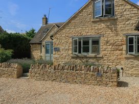 A house with stone walls and windows at 12 Manor Farm Close Kingham