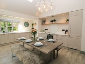 A kitchen with a dining table and chairs at 12 Manor Farm Close Kingham