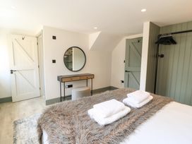 A bedroom with a bed and vanity at 12 Manor Farm Close Kingham