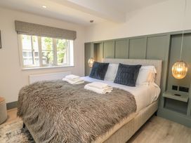 A bedroom with a bed and window at 12 Manor Farm Close Kingham