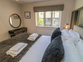 A bedroom with a bed and window at 12 Manor Farm Close in Kingham