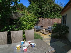 A patio with a table and chairs at 12 Manor Farm Close in Kingham