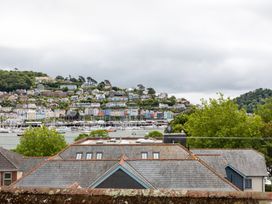 A view of houses and boats by the water at George House in Dartmouth