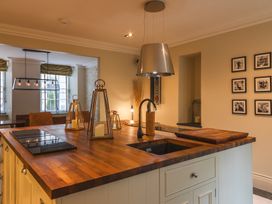 A kitchen with an island and a sink at George House in Dartmouth