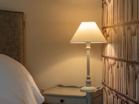 A bedroom with a lamp and nightstand at George House in Dartmouth