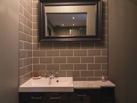 A bathroom with sink and mirror at George House in Dartmouth