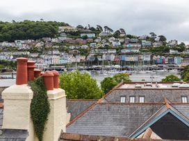 A view of rooftops and harbor with boats at George House in Dartmouth