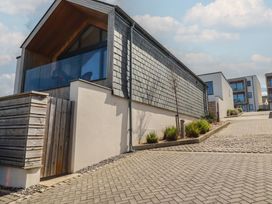 A house with a driveway and garden at Porth Cove in Porth