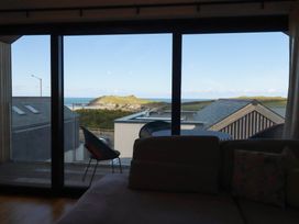 A living room with a view of the ocean at Porth Cove in Porth