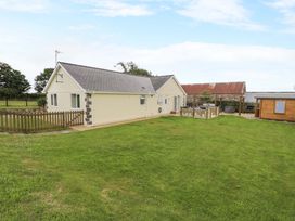 A house with a garden and wooden shed at Cae Berllan in Mynytho near Pwllheli