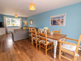 A dining room with a table and chairs at Cae Berllan in Mynytho near Pwllheli
