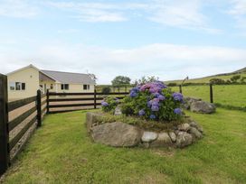 A house with a garden and flowers at Cae Berllan near Pwllheli