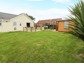 A garden with a house and shed at Cae Berllan in Mynytho near Pwllheli