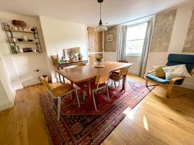 A dining room with a table and chairs at Widgeons Keel in Flushing